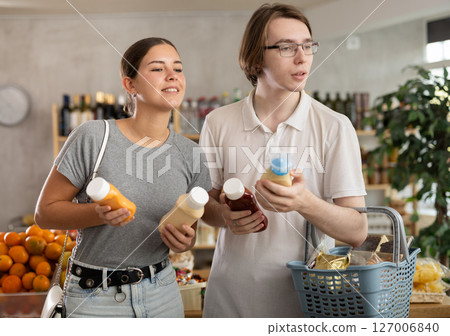 Couple young man and woman choosing sauces 127006840