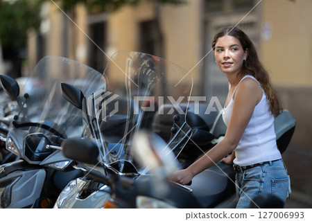Girl rents moped, starts journey at parking lot 127006993
