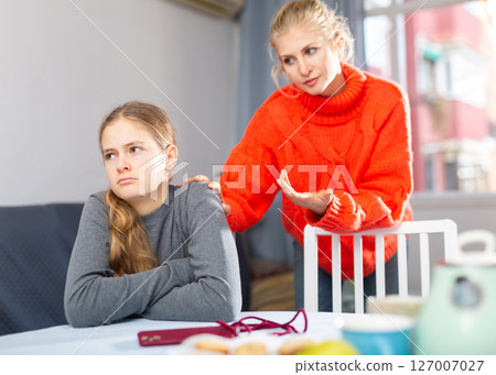 Sad teen girl after discord with her mother 127007027
