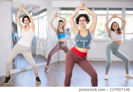 Group of woman dancing belly dancing in studio Group of woman dancing belly dancing in studio 127007146