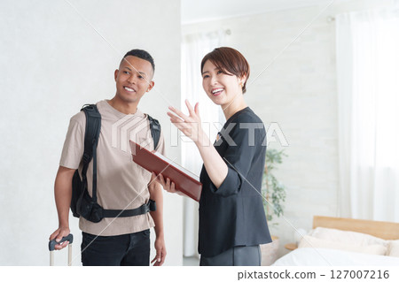 Asian hotel staff and foreign tourists 127007216