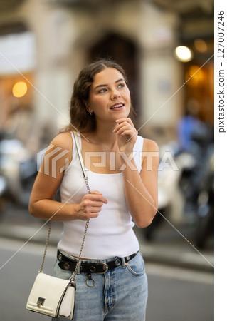 Young girl enjoying walk along summer city stree Young girl enjoying walk along summer city stree 127007246