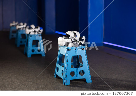 VR headsets and controllers in virtual reality gaming room VR headsets and controllers in virtual reality gaming room 127007307
