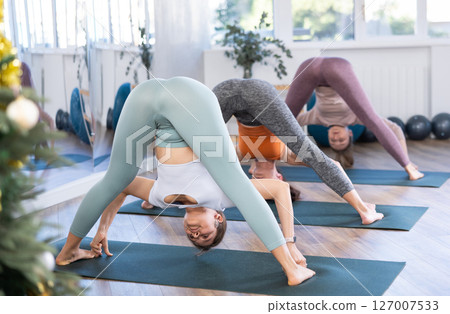 Group of women doing stretching in studio 127007533