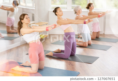 Young woman exercising with pilates band 127007651