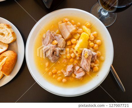 Plate with portion of hot chickpea and meat soup Plate with portion of hot chickpea and meat soup 127007721