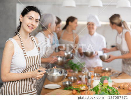 Young woman learns to cook at master class 127007871