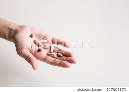 Open Hand Displaying Various Pills and Capsules, Representing Healthcare and Medicine. Open Hand Displaying Various Pills and Capsules, Representing Healthcare and Medicine. 127008173