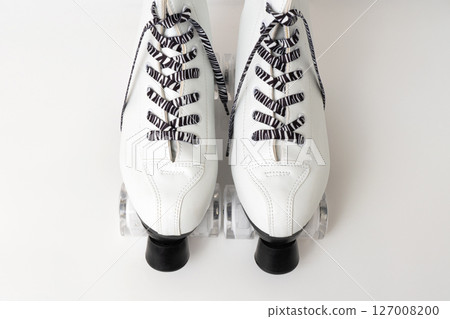 White figure roller skates with striped laces on white background 127008200