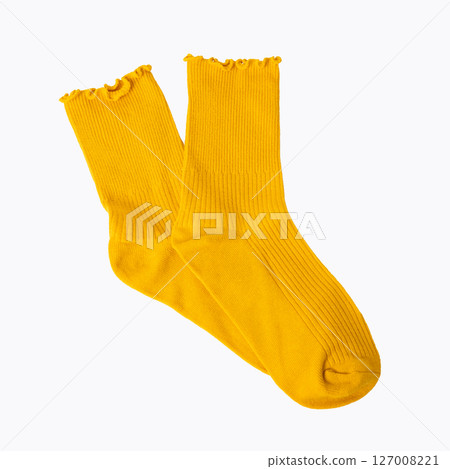 Bright yellow ruffled edge socks on white background 127008221