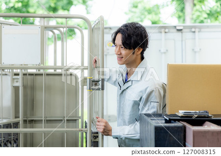 Courier man delivering luggage 127008315