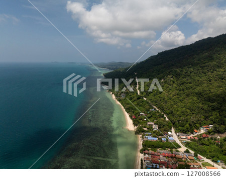 Green coastline with a winding road, forested hills, and turquoise waters meeting sandy beaches. Ko Pha Ngan, Thailand. Green coastline with a winding road, forested hills, and turquoise waters meeting sandy beaches. Ko Pha Ngan, Thailand. 127008566