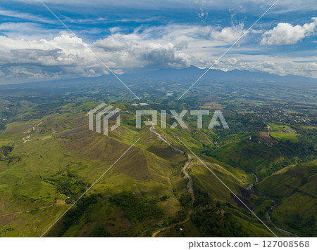 Valley in tropical mountain province under bue sky and clouds. Bukidnon, Philippines. Valley in tropical mountain province under bue sky and clouds. Bukidnon, Philippines. 127008568