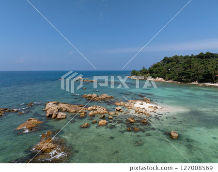 Scenic coastal rocks surrounded by vibrant turquoise waters in a serene tropical environment. Ko Pha Ngan, Thailand. Scenic coastal rocks surrounded by vibrant turquoise waters in a serene tropical environment. Ko Pha Ngan, Thailand. 127008569