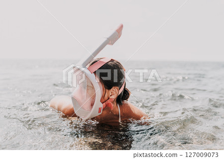 Freelance close up woman hands writing on computer. Well looking middle aged woman typing on laptop keyboard outdoors with beautiful sea view. 127009073