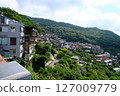 Town surrounded by mountains 127009779