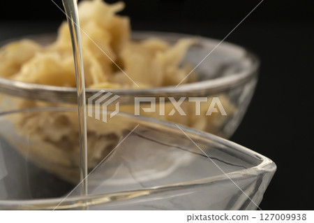 Homemade ginger syrup on a black background 127009938