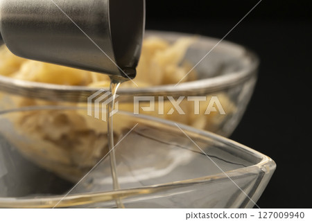 Homemade ginger syrup on a black background Homemade ginger syrup on a black background 127009940