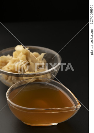 Homemade ginger syrup on a black background Homemade ginger syrup on a black background 127009943