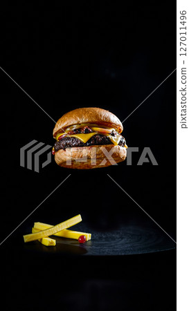 Great burger on a dark isolated phone 127011496