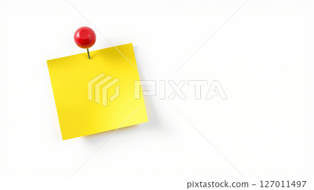 A yellow sheet of paper for notes is attached with a red pushpin to a white wall 127011497