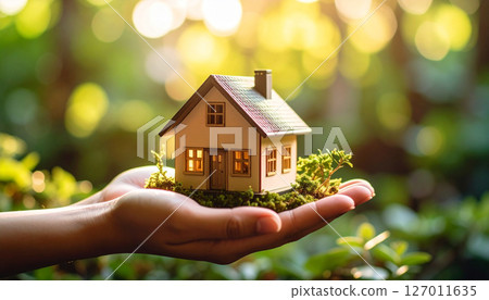 Hands holding a model house (AI-generated image) 127011635