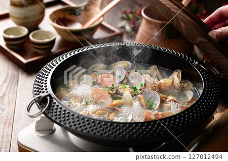Sake-steamed clams, a Japanese hot pot dish with boiling steam and broth Sake-steamed clams, a Japanese hot pot dish with boiling steam and broth 127012494