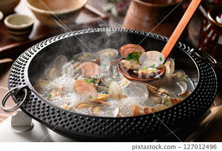 Sake-steamed clams, a Japanese hot pot dish with boiling steam and broth Sake-steamed clams, a Japanese hot pot dish with boiling steam and broth 127012496