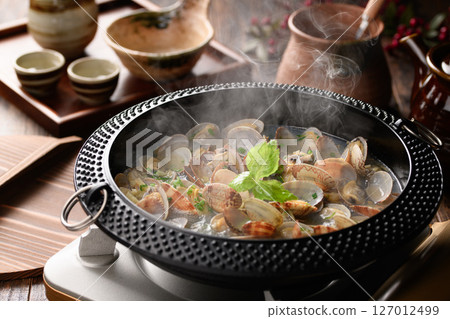Sake-steamed clams, a Japanese hot pot dish with boiling steam and broth Sake-steamed clams, a Japanese hot pot dish with boiling steam and broth 127012499