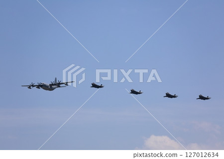 Stealth fighter jets flying in formation, F-35, mid-air refueling 127012634