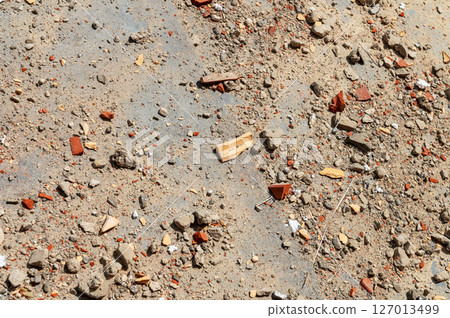 Construction waste close up. Broken bricks, demolition debris, and destruction fragments and rubbish Construction waste close up. Broken bricks, demolition debris, and destruction fragments and rubbish 127013499