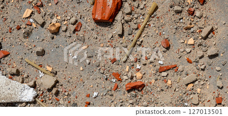 Construction waste close up. Broken bricks, demolition debris, and destruction fragments and rubbish 127013501