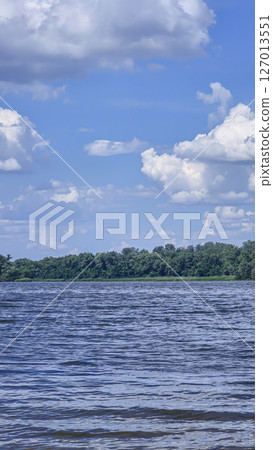 River surrounded by trees. Camping Volumetric clouds. Outdoor recreation. River surrounded by trees. Camping Volumetric clouds. Outdoor recreation. 127013551