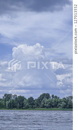 River surrounded by trees. Camping Volumetric clouds. Outdoor recreation. River surrounded by trees. Camping Volumetric clouds. Outdoor recreation. 127013552
