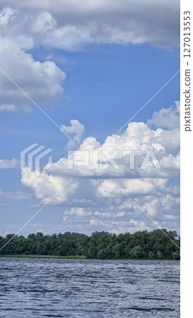River surrounded by trees. Camping Volumetric clouds. Outdoor recreation. River surrounded by trees. Camping Volumetric clouds. Outdoor recreation. 127013553