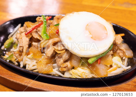 Delicious fried egg topped with pork and ginger Delicious fried egg topped with pork and ginger 127013653