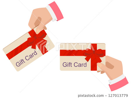 Human hand holding a gift card with ribbon isolated on white background. 127013779