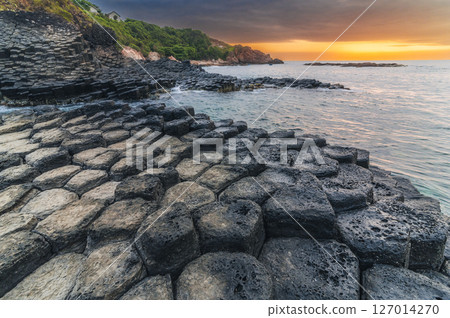 Da Dia reef or Ganh Da Dia in Phu Yen in Vietnam at sunrise. Landscape with volcanic basalt columns on rocky beach by sea Da Dia reef or Ganh Da Dia in Phu Yen in Vietnam at sunrise. Landscape with volcanic basalt columns on rocky beach by sea 127014270