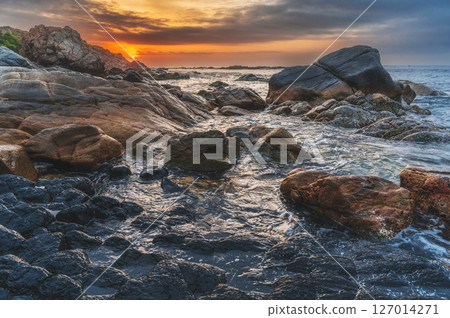 Panoramic landscape with volcanic basalt columns Ganh Da Dia on the beach by the sea. Da Dia reef in Vietnam at sunrise Panoramic landscape with volcanic basalt columns Ganh Da Dia on the beach by the sea. Da Dia reef in Vietnam at sunrise 127014271