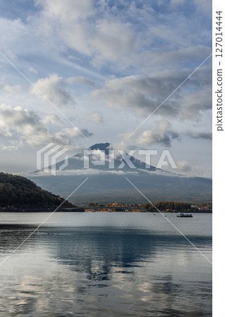 Soft clouds hover around Mount Fuji at sunrise, as Lake Kawaguchi rippling surface Soft clouds hover around Mount Fuji at sunrise, as Lake Kawaguchi rippling surface 127014444