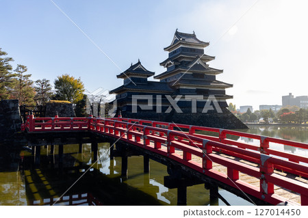 Matsumoto Castle viewed from a red wooden bridge, bathed in soft morning light Matsumoto Castle viewed from a red wooden bridge, bathed in soft morning light 127014450