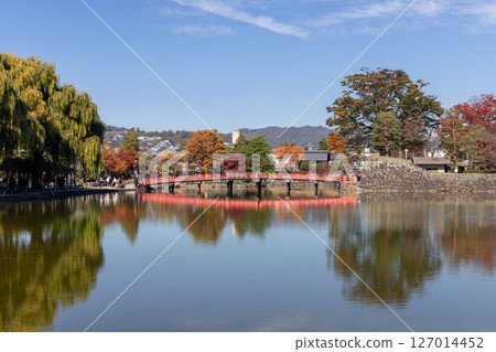 Red wooden bridge near Matsumoto Castle in Nagano, Japan 127014452