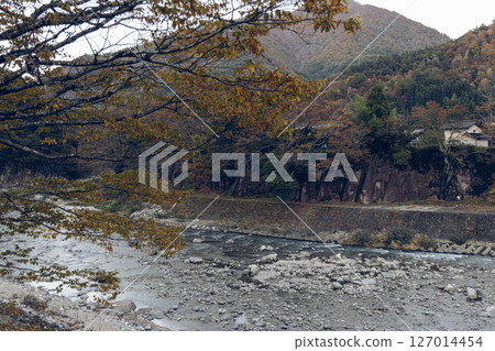 Sho River in Shirakawa-Go Japan flowing through rocky banks and forested hills Sho River in Shirakawa-Go Japan flowing through rocky banks and forested hills 127014454