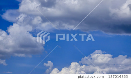 Blue sky with voluminous fluffy clouds. Thunderstorm over the river. 127014863