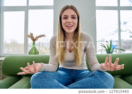 Web cam view of young woman talking looking in camera, online meeting, video call 127015493