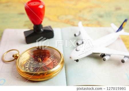 Passport with airplane and flag on white background with copy space. Passport with airplane and flag on white background with copy space. 127015991