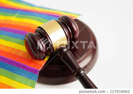 Gavel for judge lawyer on rainbow flag, symbol of LGBT pride month. 127016002