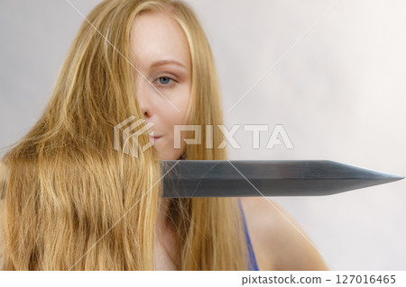 Girl with sword for haircutting Girl with sword for haircutting 127016465