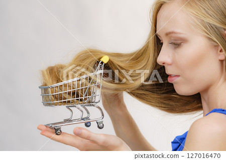 Girl with her long hair in shopping cart 127016470