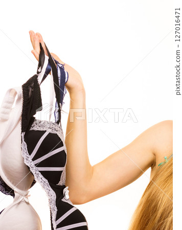 Female hand with many bras lingerie 127016471